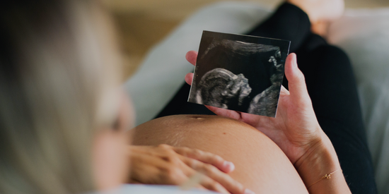 Pregnant Mom Looking At Her Sonography